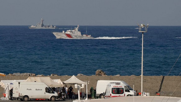KEYPIX - Vessels sail near the port of Kyrenia as an ambulance is parked on the waterfront in the Turkish-occupied northern part of Cyprus, Sunday, Aug. 30, 2026, after a catamaran-style ferry overtur ...