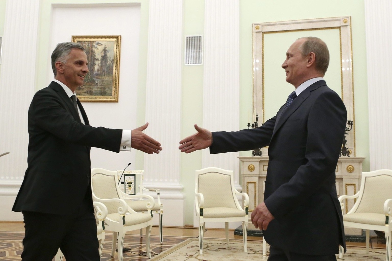 epa04195100 Russian President Vladimir Putin (R) shakes hands with Swiss President and OSCE Chairman Didier Burkhalter (L) during a meeting at the Kremlin in Moscow, Russia, 07 May 2014. Burkhalter, w ...