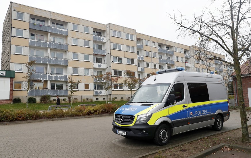 epa06299846 A police van is parked next to the building where a Syrian citizen was arrested this morning during a police raid in the outskirts of Schwerin, Germany, 31 October 2017. The 19 year old su ...