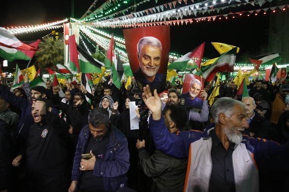 epa11254922 A photo of deceased Iranian Quds Forces commander Qasem Soleimnai is held up during an anti-Israel demonstration in Palestine Square in Tehran, Iran, April 1, 2024. According to IRNA News A...