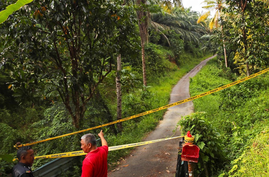 epa07770769 Police cordon an area as the search and rescue operation for 15-year-old Nora Quoirin from London is continued, in Seremban, Negeri Sembilan, Malaysia, 13 August 2019. Nora disappeared whi ...