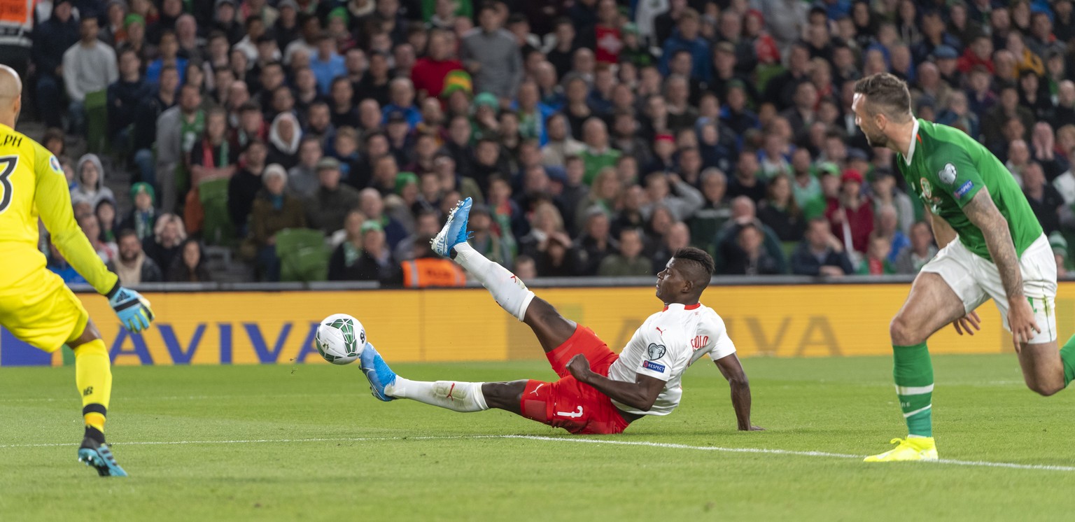 Switzerland&#039;s Breel Embolo, center, falls down during the UEFA Euro 2020 qualifying Group D soccer match between the Republic of Ireland and Switzerland at the Aviva stadium in Dublin, Ireland, o ...