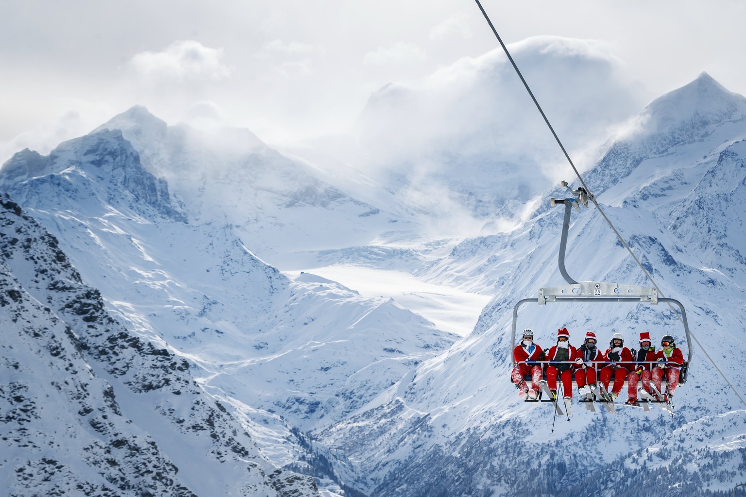 epa06363921 People dressed as Santa Claus gather in the alpine ski resort of Verbier, Switzerland, 02 December 2017. Thousands of skiers dressed as Santa Claus and Saint Nicholas were granted free acc ...