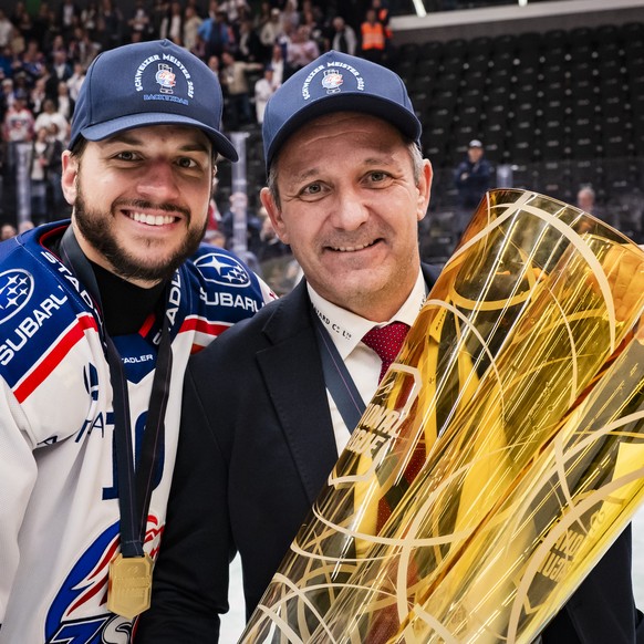 Sven Andrighetto (ZSC) and ZSC Lions&#039; Head coach Marco Bayer celebrate with the trophy of Swiss Champion after winning by 2:3 during the fifth leg of the National League Swiss Championship final  ...