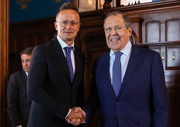 epa10084187 A handout photo made available by the press service of the Russian Foreign Affairs Ministry shows Russian Foreign Minister Sergei Lavrov (R) and Hungarian Foreign and Trade Minister Peter  ...