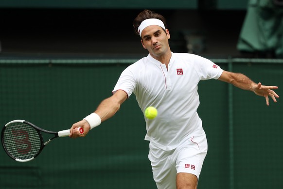 epa06863776 Roger Federer of Switzerland returns to Lukas Lacko of Slovakia during their second round match at the Wimbledon Championships at the All England Lawn Tennis Club, in London, Britain, 04 J ...