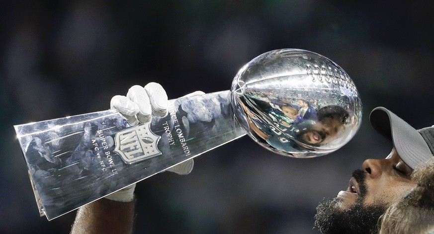 Philadelphia Eagles' Brandon Graham holds up the Vince Lombardi Trophy after the NFL Super Bowl 52 football game against the New England Patriots, Sunday, Feb. 4, 2018, in Minneapolis. The Eagles won  ...
