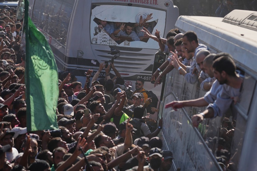 People gather to greet freed Palestinian prisoners arriving on buses in the Gaza Strip after their release from Israeli jails under a ceasefire agreement between Hamas and Israel, outside Nasser Hospi ...