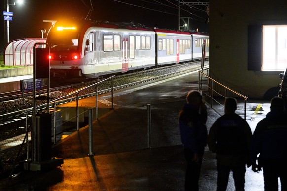 Vaud cantonal police officers watch the Travys train where a hostage-taking incident took place at Essert-sous-Champvent station, Switzerland, Thursday, 8, February, 2024. A hostage-taking incident to ...