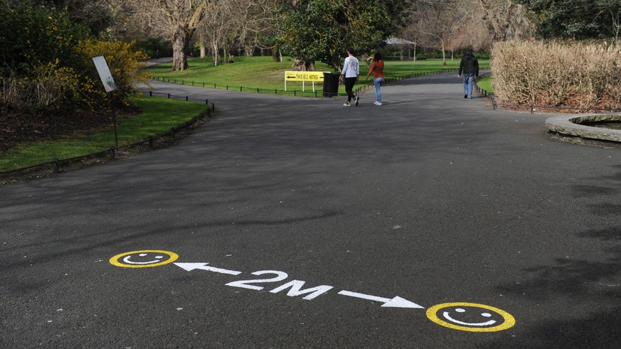 epa08324080 A painted sign asking people to stay two-meters apart is seen in Saint Stephen's Green Dublin City, Ireland, 26 March 2020. In response to the Covid-19 pandemic the Irish government h ...