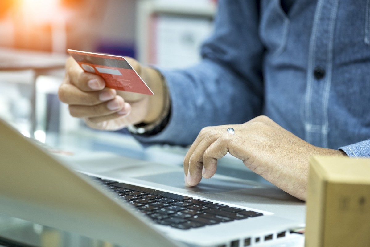 Hands holding cradit card and using computer labtop payment onlind