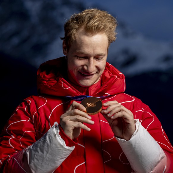 KEYPIX - Bronze medalist Switzerland's Marco Odermatt looks at his bronze medal as he poses for a portrait after the men's alpine skiing Super-G race at the 2026 Olympic Winter Games at the  ...