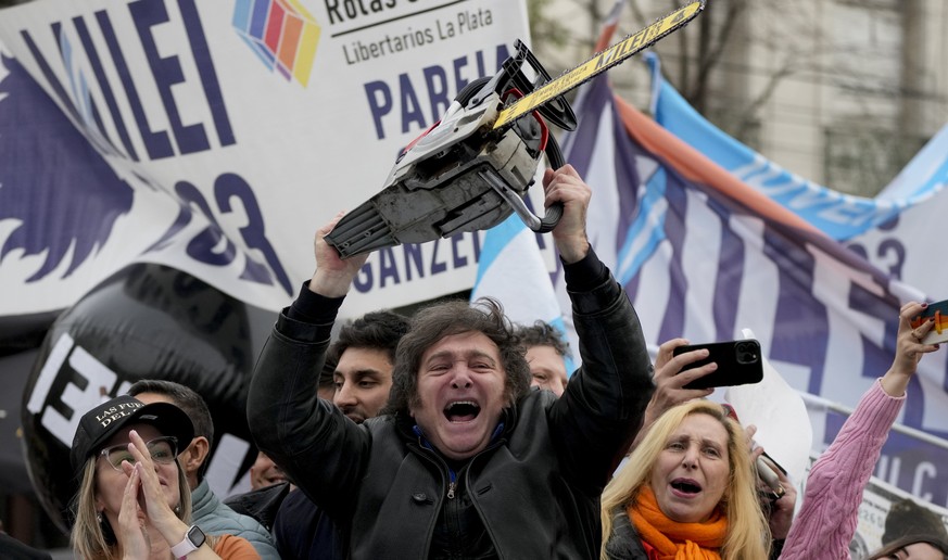 FILE - Presidential hopeful of the Liberty Advances coalition Javier Milei brandishes a chainsaw during a rally in La Plata, Argentina, Tuesday, Sept. 12, 2023. During campaign stops and interviews Mi ...