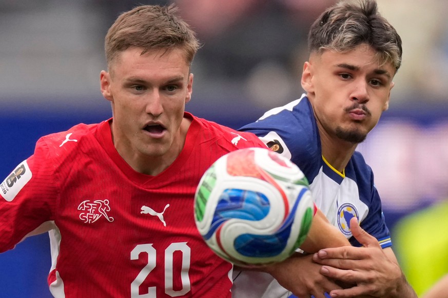 KEYPIX - Switzerland's Michel Aebischer, left, and Bosnia's Kerim Alajbegovic eye the ball during the World Cup Group B soccer match between Switzerland and Bosnia in Inglewood, Calif., near ...