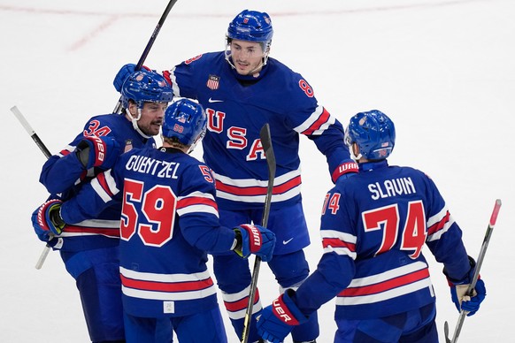 United States' Jake Guentzel, second left, celebrates after scoring his side's fifth goal during a preliminary round match of men's ice hockey between United States and Denmark at the 2 ...