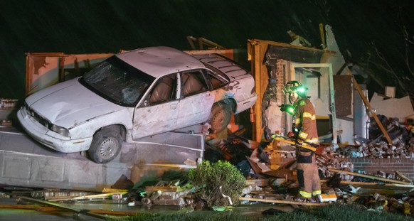 A Wichita, Kan., firefighter searches a home in Andover, Kan., Friday, April 29, 2022, after a tornado ripped through the area just east of Wichita. (Travis Heying/The Wichita Eagle via AP)