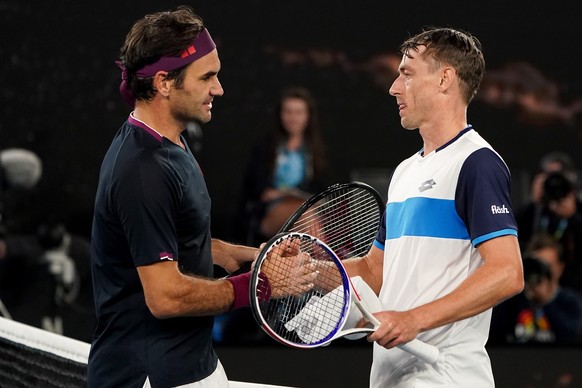 epa08159275 Roger Federer of Switzerland (L) shakes hands with John Millman of Australia following their third round match on day five of the Australian Open tennis tournament at Rod Laver Arena in Me ...