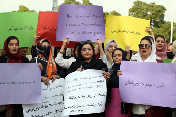 epa11402664 Supporters of the Independent Coalition of Afghan Women&#039;s Protest Movement hold placards during a protest to demand rights of Afghan women from Taliban government in Islamabad, Pakist ...
