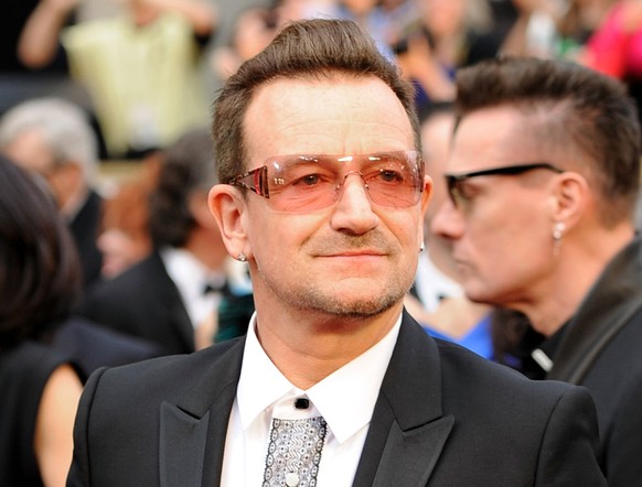 FILE - In this March 2, 2014 file photo, Bono arrives at the Oscars at the Dolby Theatre in Los Angeles. A New York City doctor says U2 singer Bono suffered multiple fractures and had to have two surg ...