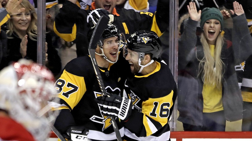 Pittsburgh Penguins' Jason Zucker (16) celebrates his goal with Sidney Crosby (87) during the second period of the team's NHL hockey game against the Montreal Penguins in Pittsburgh, Friday, ...