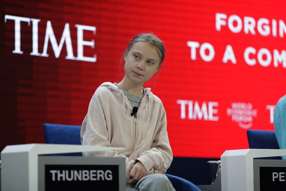 Swedish environmental activist Greta Thunberg takes her seat prior to the opening session of the World Economic Forum in Davos, Switzerland, Tuesday, Jan. 21, 2020. The 50th annual meeting of the forum will take place in Davos from Jan. 20 until Jan. 24, 2020. (AP Photo/Markus Schreiber)