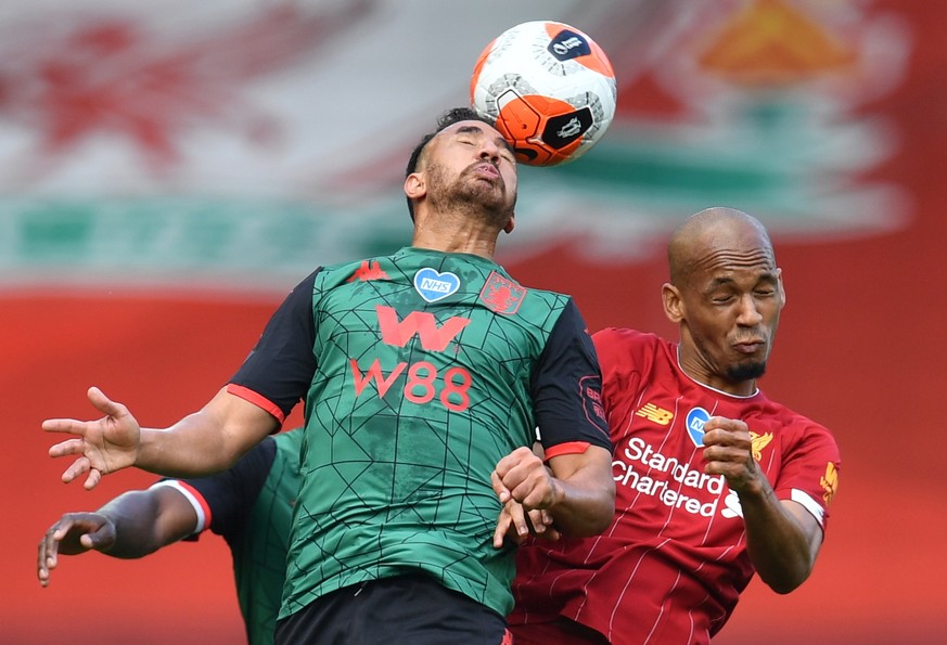 epa08529307 Fabinho of Liverpool (R) in action against Trezeguet of Aston Villa (L) during the English Premier League soccer match between Liverpool FC and Aston Villa at Anfield stadium in Liverpool, ...