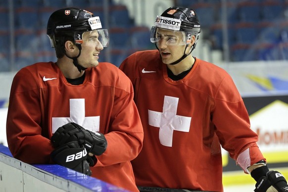 Switzerland&#039;s Roman Josi, left, and Nino Niederreiter, right, speak together, during a training session at the IIHF Ice Hockey World Championships at the Hovet Arena in Stockholm, Sweden, on Mond ...