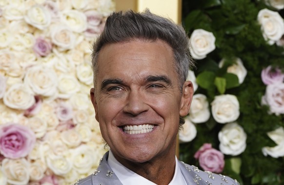 Robbie Williams arrives at the 82nd Golden Globes on Sunday, Jan. 5, 2025, at the Beverly Hilton in Beverly Hills, Calif. (Photo by Jordan Strauss/Invision/AP)
Robbie Williams