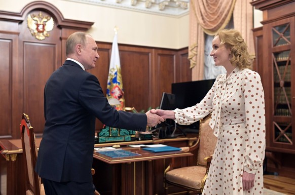 Russia Putin 8136489 09.03.2022 Russian President Vladimir Putin shakes hands with Presidential Commissioner for Children s Rights Maria Lvova-Belova during their meeting at the Kremlin in Moscow, Rus ...