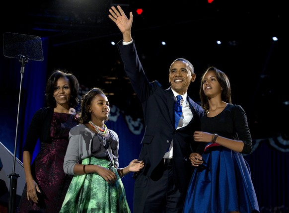 FILE - In this Nov. 7, 2012, file photo, President Barack Obama waves as he walks on stage with first lady Michelle Obama and daughters Malia and Sasha at his election night party in Chicago. Former P ...