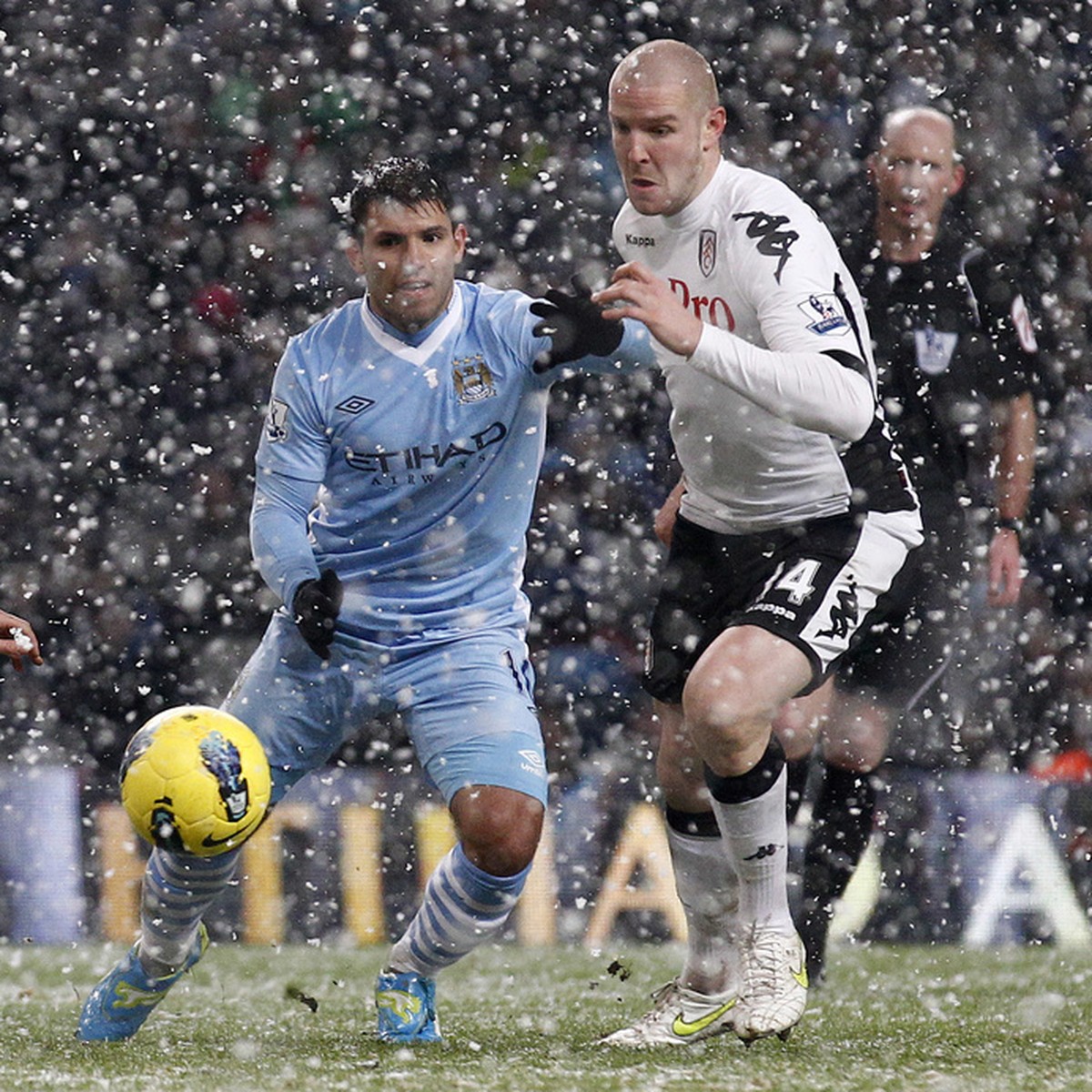 Manchester City's Sergio Aguero, center right, fights for the ball against Fulham's Philippe Senderos, right, and Stephen Kelly, bottom left, during their English Premier League soccer match ...