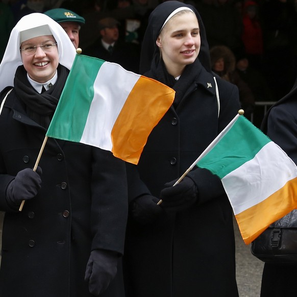 Nuns wave Irish flags outside St. Patrick&#039;s Cathedral during the St. Patrick&#039;s Day parade in New York March 17, 2014. About one million spectators, mostly dressed in green, streamed into New ...