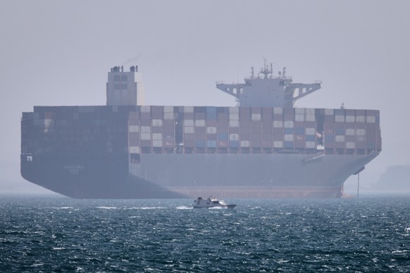 A container ship sits at anchor as a small motorboat passes in the foreground in the Strait of Hormuz off Bandar Abbas, Iran, Saturday, May 2, 2026. (Amirhosein Khorgooi/ISNA via AP)
Iran War Strait o ...