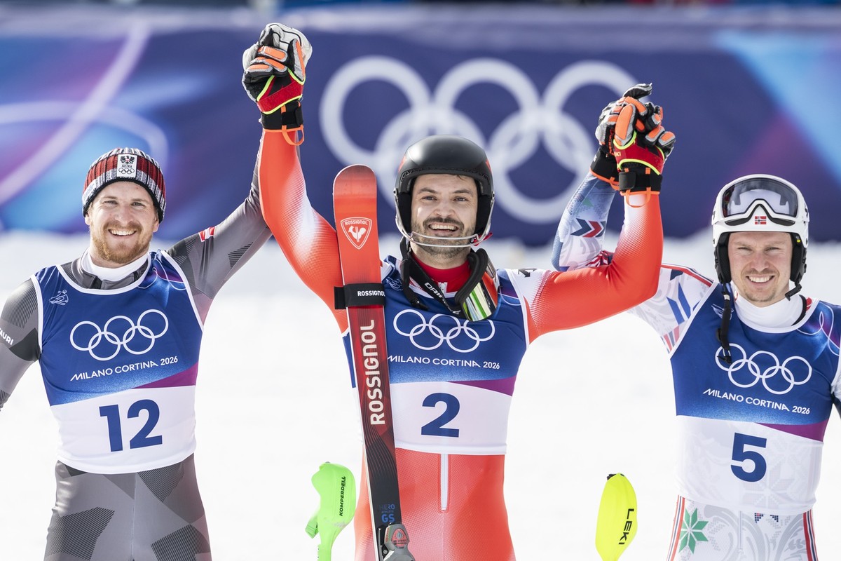 KEYPIX - Switzerland's Loic Meillard, center, celebrates as the winner with second Austria's Fabio Gstrein, left, and third Norway's Henrik Kristoffersen, in the finish area during the  ...