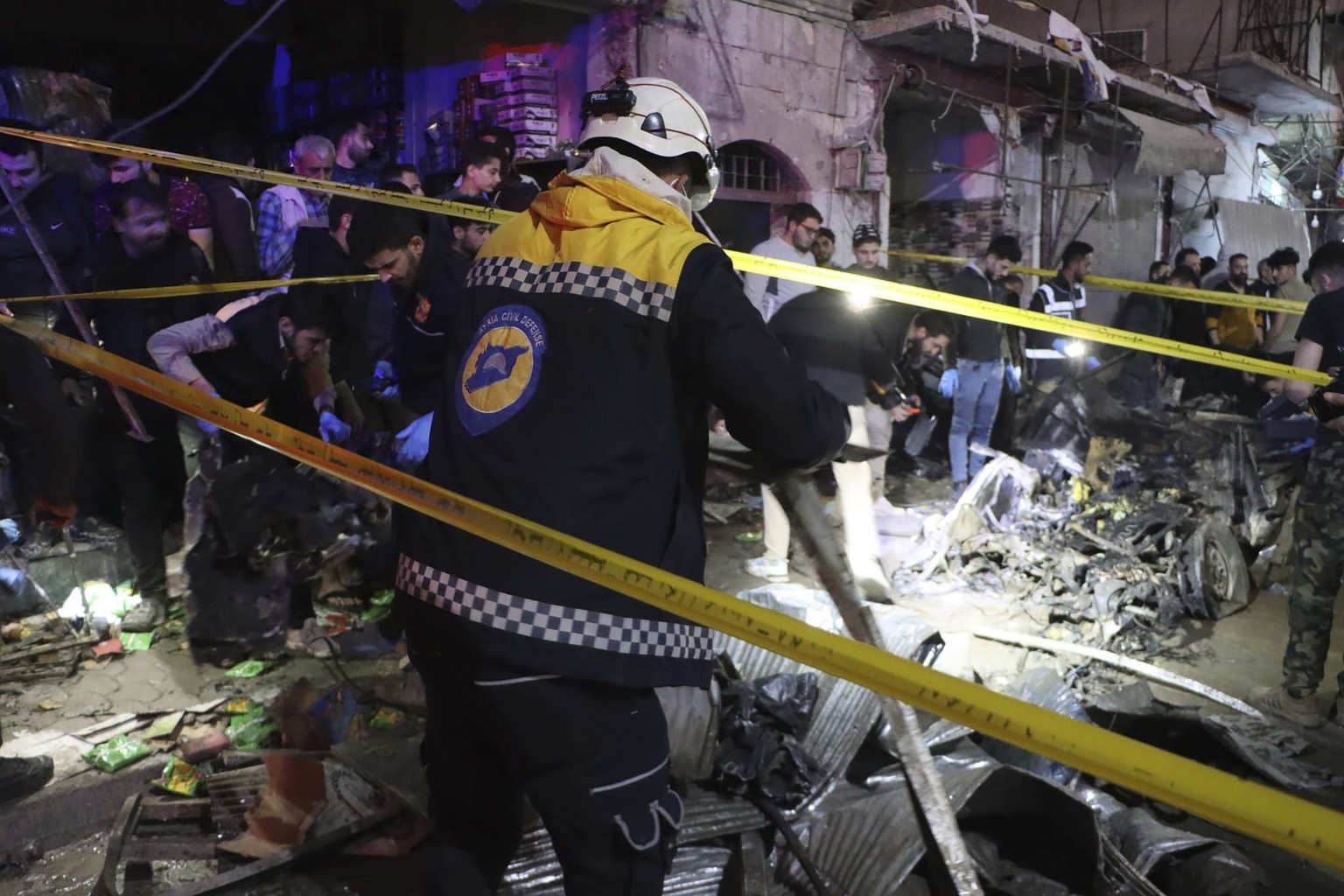 In this photo provided by the Syrian Civil Defense White Helmets, which has been authenticated based on its contents and other AP reporting, Syrian White Helmet civil defense workers search for casual ...