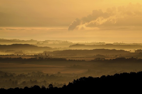 Water vapor rises from the cooling towers of the Bugey nuclear plant of Saint-Vulbas, around Lyon, central France, early Tuesday, Oct. 26, 2021. Weeks before leaders gather for a U.N. summit in Glasgo ...