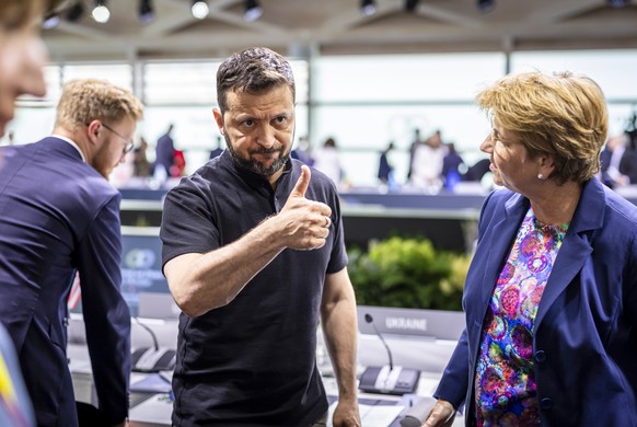 Ukrainian President Volodymyr Zelenskyy, left, reacts next to Swiss Federal President Viola Amherd after a closing plenary session during the Summit on peace in Ukraine, in Stansstad near Lucerne, Swi ...