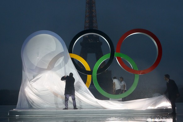 FILE - Paris officials unveil a display of the Olympic rings on Trocadero plaza that overlooks the Eiffel Tower, after the vote awarding the 2024 Games to the French capital, in Paris, Wednesday, Sept ...