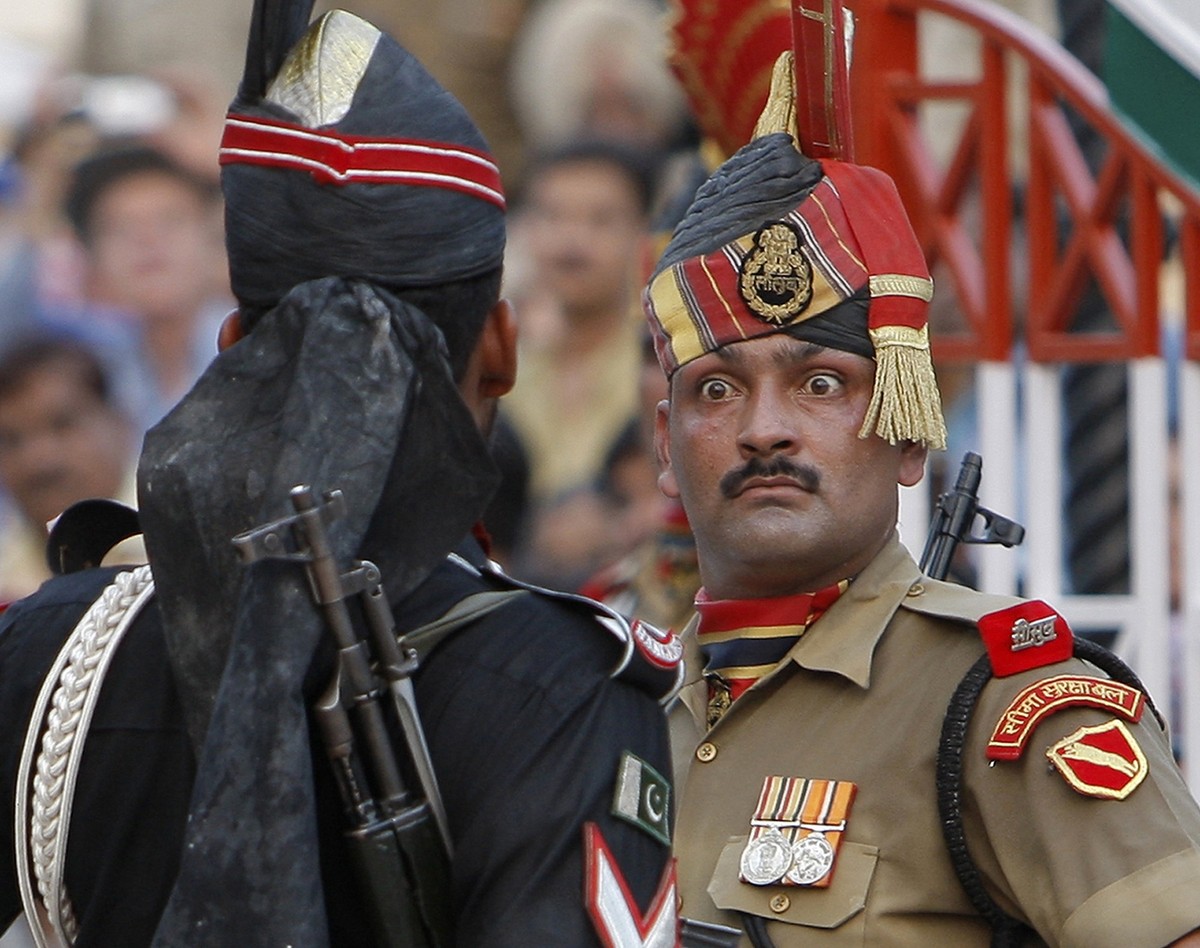 File- In this July 19, 2009 file photo, an Indian Border Security Force soldier, right, and a Pakistani Rangers soldier face one another at a daily closing ceremony at the Wagah border post near Lahor ...