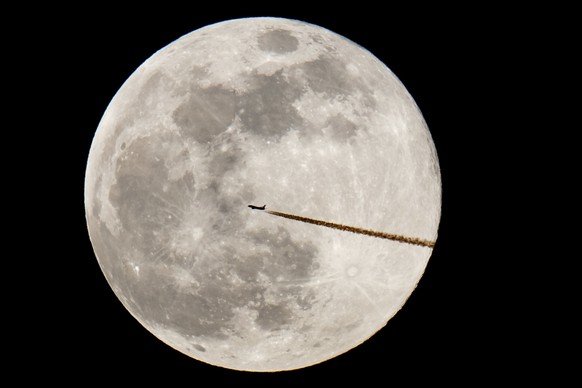A plane flies past a full moon, Tuesday, Feb. 19, 2019, in Nuremberg, Germany. Tuesday’s full moon, or supermoon, appears brighter and bigger than other full moons because it is close to its perigee,  ...