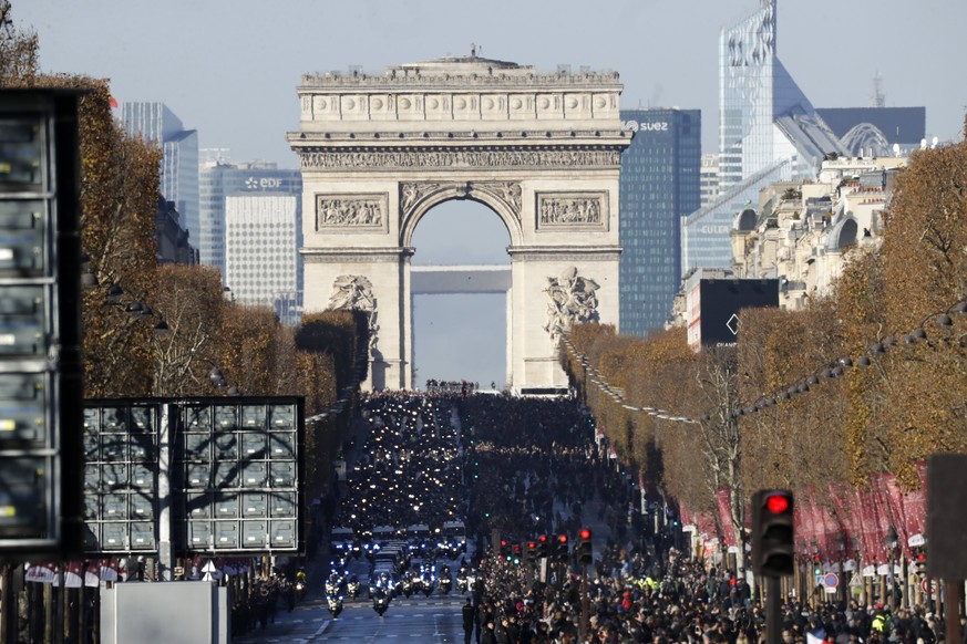 epa06378188 Followed by hundreds of bikers, the funeral cortege with the coffin of the late French rock legend Johnny Hallyday drives down the Champs Elysees avenue to the Concorde Square ahead of the ...