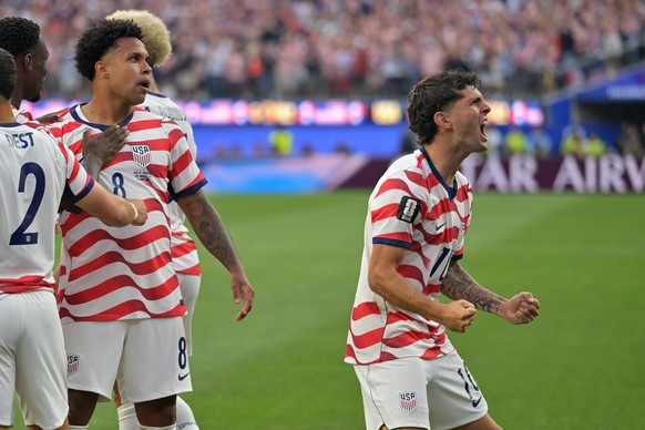 United States' Christian Pulisic, right, celebrates with teammates after an own goal by Paraguay's Damian Bobadilla during the World Cup Group D soccer match in Inglewood, Calif., near Los A ...