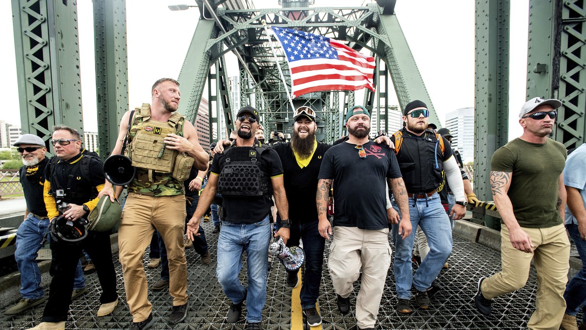 FILE - Members of the Proud Boys, including organizer Joe Biggs, third from right, march across the Hawthorne Bridge during an "End Domestic Terrorism" rally in Portland, Ore., on Saturday,  ...