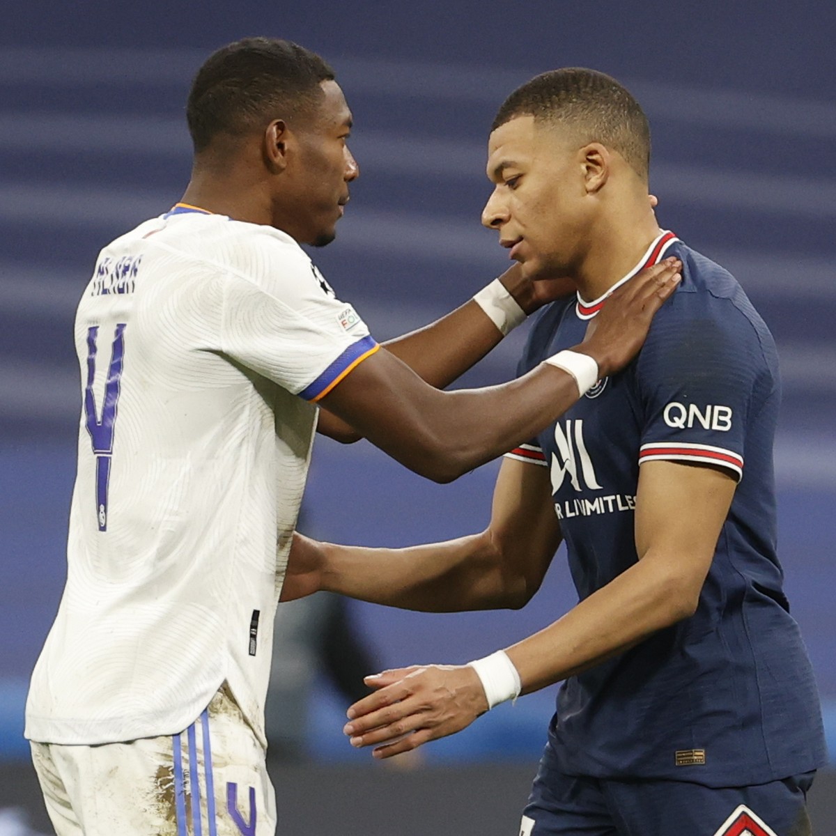 epa09813714 Real Madrid's David Alaba (L) and Paris Saint-Germain's Kylian Mbappe (R) react after the UEFA Champions League round of 16, second leg soccer match between Real Madrid and Paris ...