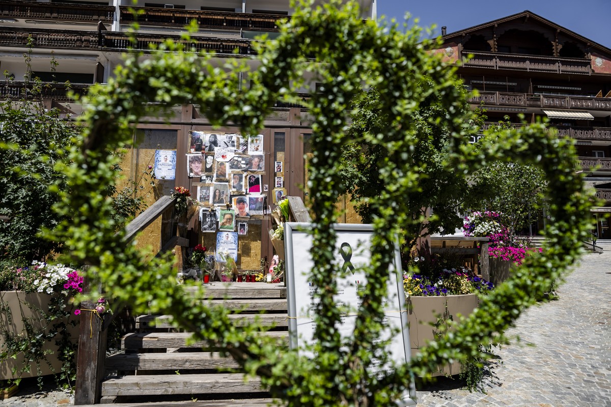 Portraits of the young victims are displayed at the entrance of the bar "Le Constellation" six moths later the deadly fire, in Crans-Montana, Switzerland, Thursday, July 9, 2026. Forty-one p ...
