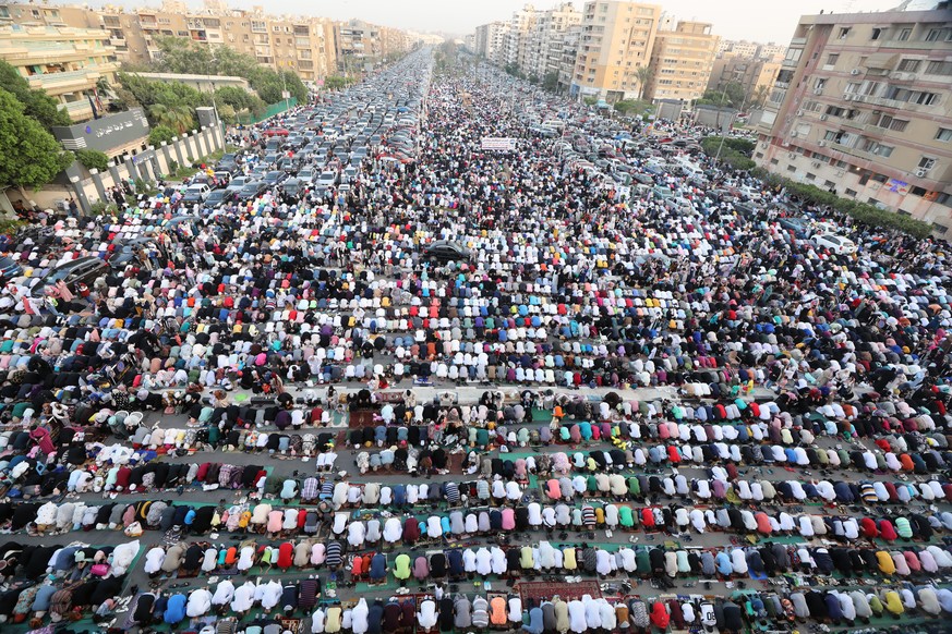 epa09922017 People attend Eid al-Fitr prayers outside Al-Seddik Mosque in Cairo, Egypt, 02 May 2022. Muslims around the world celebrate Eid al-Fitr, the three days festival marking the end of Ramadan. ...