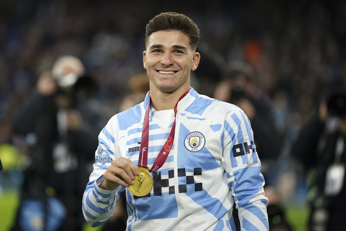 Manchester City's Julian Alvarez of Argentina smiles as he holds his World Cup winners medal before the English Premier League soccer match between Manchester City and Everton at the Etihad Stadi ...