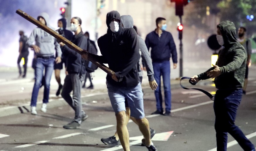 epa08533707 Protesters in action during clashes with police outside the Serbian Parliament building in Belgrade, Serbia, 07 July 2020 (issued 08 July 2020). Hundreds gathered to protest after Presiden ...