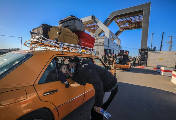 epa08980250 Palestinians wait to cross into Egypt through the Rafah border crossing between Gaza Strip and Egypt after its closure from March 2020 as a precautionary measure against the spread of the  ...
