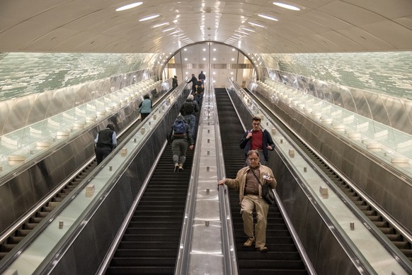 epa10429454 People ride the rail escalator to the new main terminal during the opening day of the LIRR train service between Jamaica and Grand Central Madison in New York, New York, USA, ...
